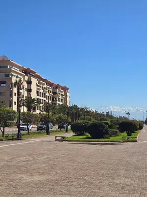 a park with benches in front of a building at Appart de luxe Hivernage Menara Mall Gueliz in Marrakech