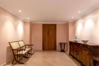 a room with a chair and a table and a door at Appart de luxe Hivernage Menara Mall Gueliz in Marrakech