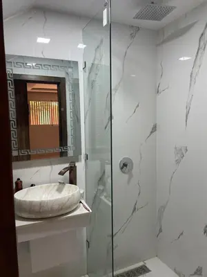 a bathroom with a sink and a glass shower at House of Jade Marrakech in Marrakech
