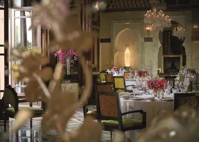 a dining room with tables and chairs with flowers at Royal Mansour Marrakech in Marrakech