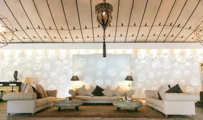 a living room with two couches and a chandelier at Lodge K in Marrakech