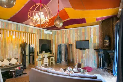 a living room with a couch and a tv at Lodge K in Marrakech