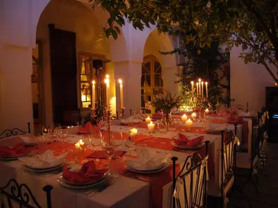 a long table with candles on it in a room at Riad Clémentine in Marrakech