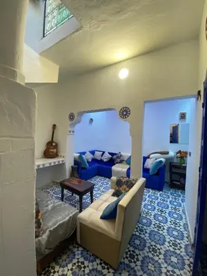 a living room with a couch and a table at Dwira in Marrakech