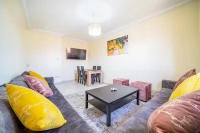 a living room with a couch and a table at Appartement 2 chambre 5min Aéroport in Marrakech