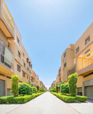 an empty street in front of apartment buildings at Appartement 2 chambre 5min Aéroport in Marrakech