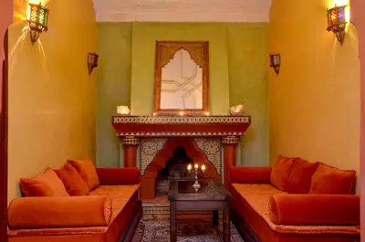 a living room with two couches and a fireplace at Riad Manissa in Marrakech