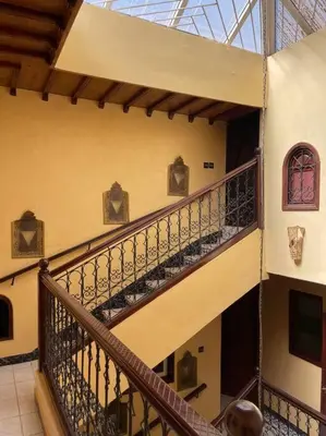 a spiral staircase in a building with a glass ceiling at Dxb Riad 4 suites in Marrakech