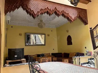 a living room with a table and a couch at Dxb Riad 4 suites in Marrakech