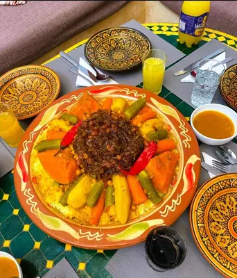 a table with a plate of food on a table at Dar Nossa in Marrakech