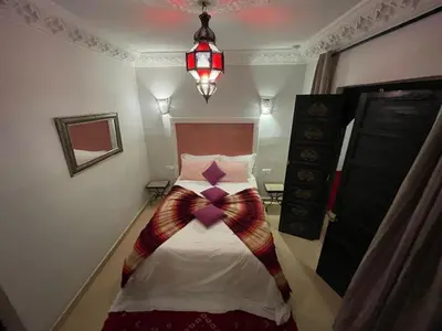 a bedroom with a bed with a bow on it at Dar Nossa in Marrakech