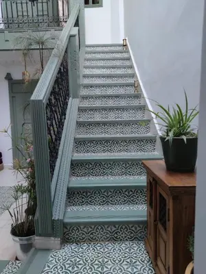 a staircase in a house with a tile floor at RZ22, 5 min de Jemaa El Fna, 4 Pers, Fibre Optique Wi-Fi in Marrakech