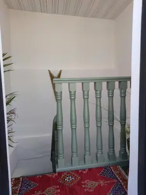 a console table with a glass top on a stairway at RZ22, 5 min de Jemaa El Fna, 4 Pers, Fibre Optique Wi-Fi in Marrakech