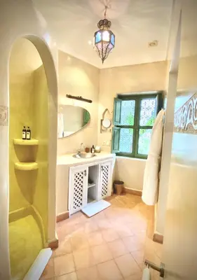 a bathroom with a sink and a mirror at Riad Dar Adal exclusivité 2 à 6 personnes petit déjeuner compris place jemaa El fna in Marrakech