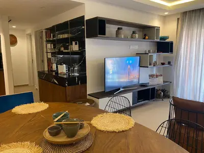 a living room with a table and a television at Luxueux Appart Hivernage avec vue sur L''Atlas in Marrakech