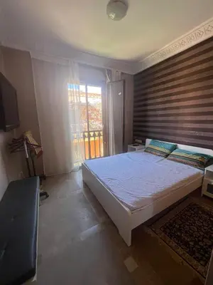 a bedroom with a large bed and a window at appartement dans Jardin de l'atlas in Marrakech
