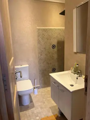 a bathroom with a white toilet and a sink at appartement dans Jardin de l'atlas in Marrakech
