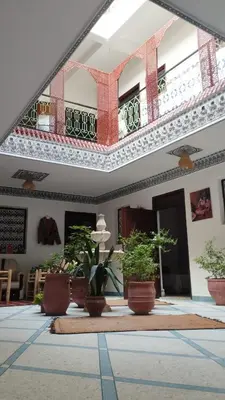 a building with potted plants and a balcony at marrakesh riad in Marrakech