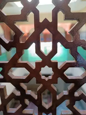 a close up of a wooden pattern on a wall at marrakesh riad in Marrakech