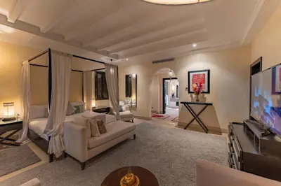 a living room with a bed and a tv at Luxury Villa GoldPalm Marrakech in Marrakech