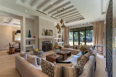 a living room with a couch and a table at Luxury Villa GoldPalm Marrakech in Marrakech