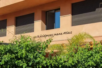 a building with a sign on the side of it at APP. Traversant au GUELIZ + Piscine sur le toit in Marrakech