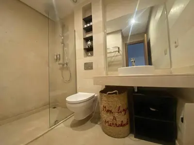 a bathroom with a toilet and a sink and a shower at APP. Traversant au GUELIZ + Piscine sur le toit in Marrakech