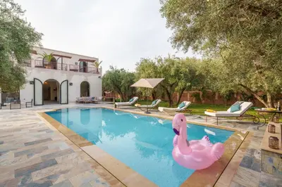 a swimming pool with a pink flamingo in a backyard at Villa Souad 5 Suites - Parking & Piscine Privée in Marrakech