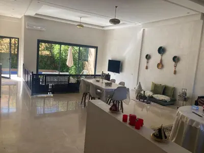 a living room with a table and a couch at Family Palms Luxe Villa Marrakech with Private Pool in Marrakech