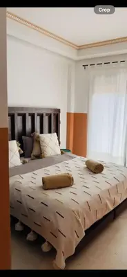 a bedroom with a large bed with pillows on it at Appartement centre Guéliz avec terrasse spacieuse in Marrakech