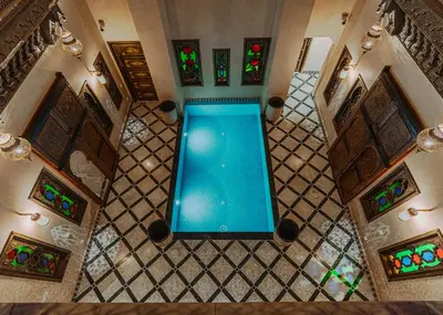 an overhead view of a swimming pool in a house at Riad Deluxe in Marrakech