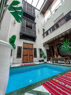 a swimming pool in the middle of a building at Riad Deluxe in Marrakech