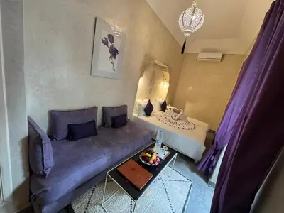 a small living room with a couch and a bed at Riad Sapphire & Spa in Marrakech