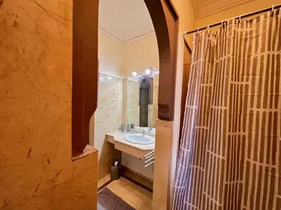 a bathroom with a sink and a shower curtain at The Majestic Marrakesh Villa 2 in Marrakech