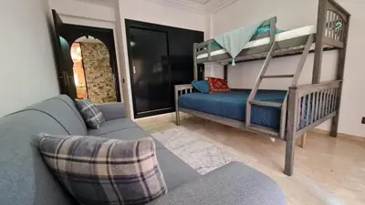 a living room with a couch and bunk beds at Apartamento Residencia Kasbah de Marrakech 1 Gueliz in Marrakech