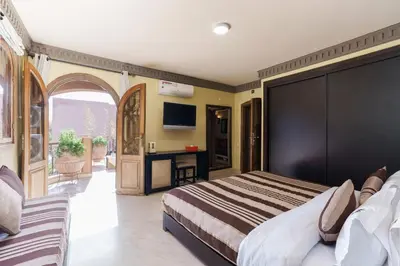 a hotel room with a bed and a desk at Luxury Villa 6 ROOMS with Pool - Marrakech Center in Marrakech