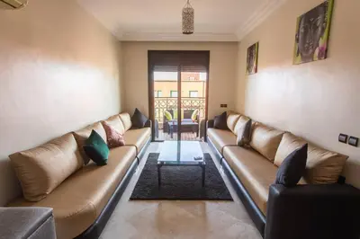 a living room with brown leather couches and a table at A stunning 2 bedroom Hivernage in Marrakech