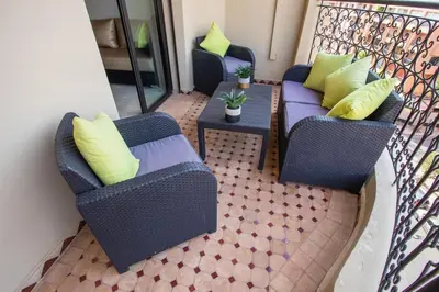 a balcony with two chairs and a table at A stunning 2 bedroom Hivernage in Marrakech