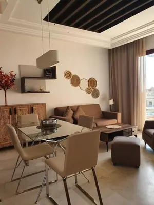 a living room with a table and a couch at Vizir Center Appartements in Dar Caïd Layadi