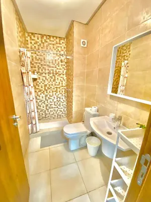 a bathroom with a toilet and a sink at Appartement avec piscine en face à la gare gueliz in Marrakech
