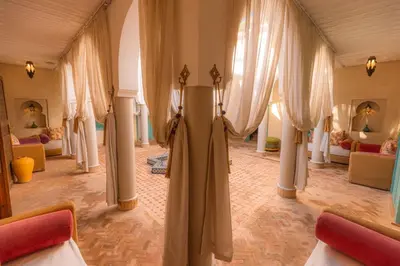 a large room with curtains and tables and chairs at Le Palais Averroes - Adults Only in Marrakech
