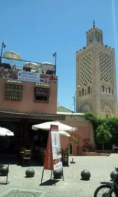 a building with an umbrella and a clock tower at Maison Alegria , Heart of Medina in Marrakech