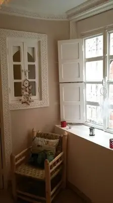 a room with a table and a window and a chair at Maison Alegria , Heart of Medina in Marrakech