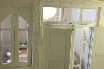 a room with a door and a window and a mirror at Maison Alegria , Heart of Medina in Marrakech