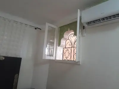 a window in a white room with a curtain at RIAD FOUZIA in Marrakech