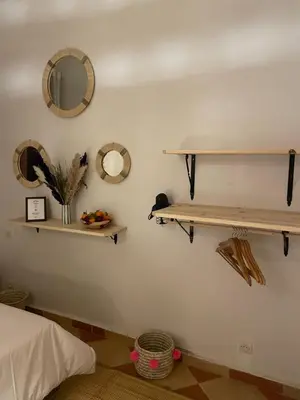 a room with shelves on the wall and a bed at Riad Hanya in Marrakech
