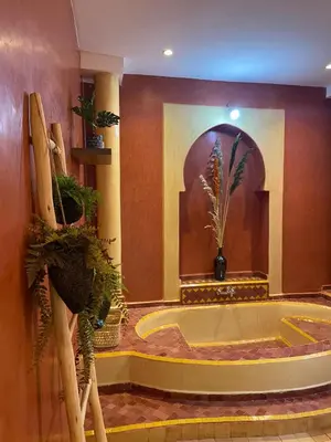 a bathroom with a tub with plants in it at Le riad de Salima, Noor Es Saadi design in Marrakech