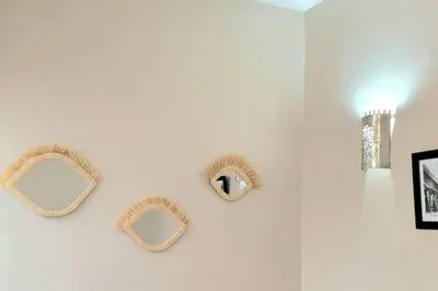 two mirrors on a white wall in a bathroom at Riad l'Empire in Marrakech