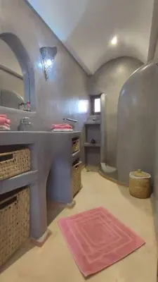 a bathroom with a sink and a counter with a pink rug at RIAD PRIVATISÉ 3 Chambres 6 Personnes Place Jemma El Fna in Marrakech