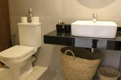 a bathroom with a white toilet and a sink at STUDIO MODERNE PROCHE MACDO RTE CASA in Marrakech